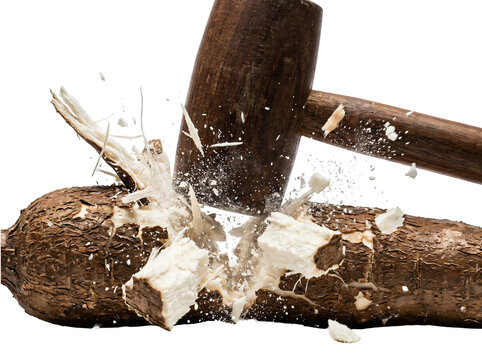 Hammer breaking wood with flying splinters and dust particles.