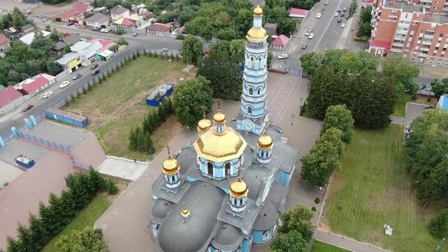 UFA, RUSSIA. AUG 12, 2022: Aerial view of the striking blue and white Cathedral of the Nativity of the Blessed Virgin Mary with golden domes