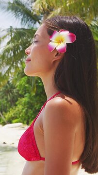 French Polynesia video of woman in bikini relaxing on perfect beach on Bora Bora vacation travel. Completely unretouched, model has no makeup. Real person. Raw footage.