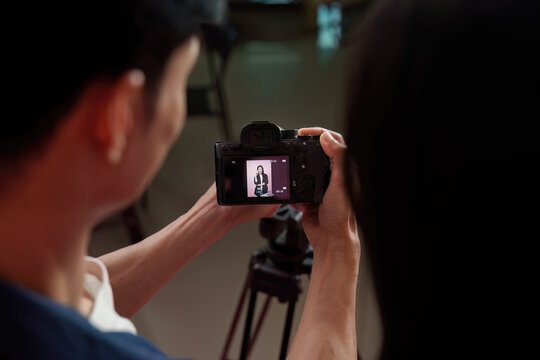 Camera screen showing model preview during photo shoot in studio