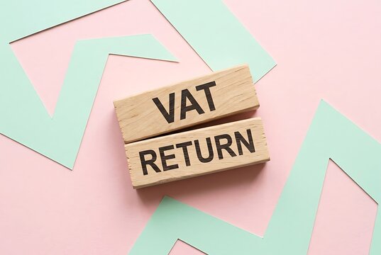 Wooden blocks with "VAT RETURN" text on pastel background. Finance and accounting concept