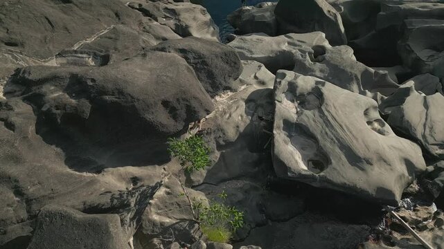 Aerial view approaches polished quartzite slabs carved into rounded potholes, narrow channels and natural basins by continuous water erosion, Vale da Lua, Alto Paraiso de Goias, Chapada dos Veadeiros