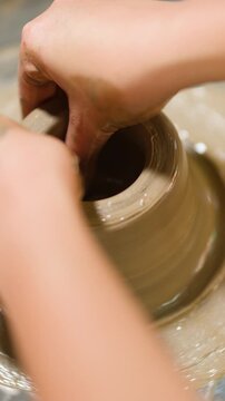 Artisan Hands Shaping Wet Clay on a Pottery Wheel in Thailand