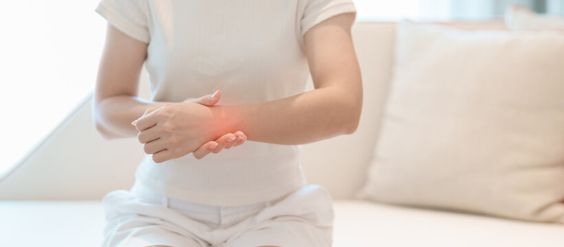 Woman having wrist pain for Carpal Tunnel Syndrome, Wrist Tendinitis, muscle ache, De Quervain s tenosynovitis, ergonomic, Hand Osteoarthritis, Office syndrome and Parkinson disease concept