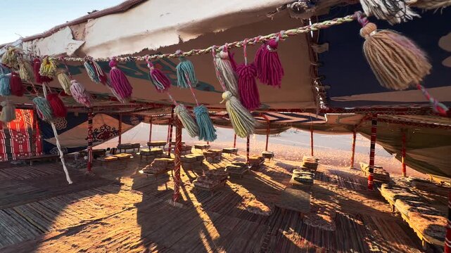 Close Up of Colorful Tassels Hanging inside Traditional Bedouin Dining Tent at Sunset in Sinai Desert