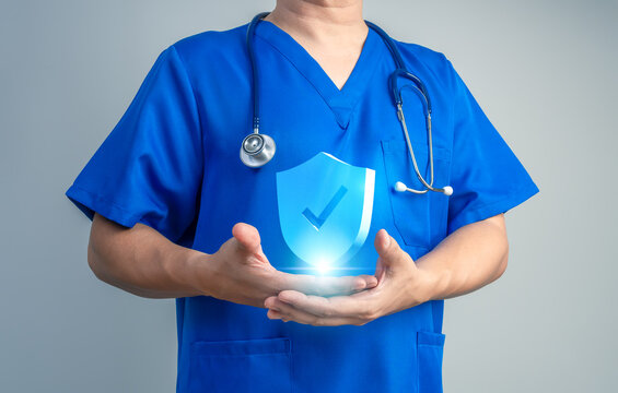 Healthcare protection concept with medical professional presenting security shield, representing patient safety, trusted healthcare, medical security, health insurance, quality care, risk prevention.