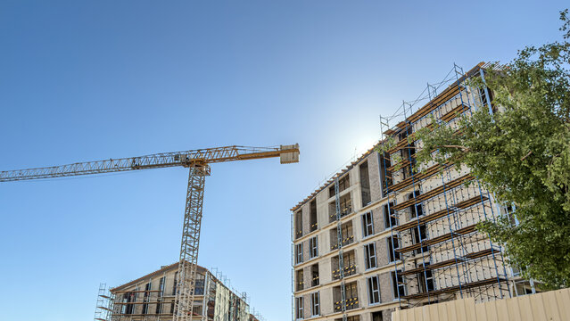 city construction site on a sunny day. multistorey apartment buildings under construction.