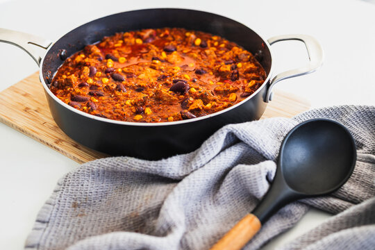 homemade vegetarian tempeh kidney bean chilli with corn in cooking pot