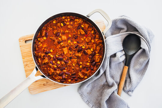 homemade vegetarian tempeh kidney bean chilli with corn in cooking pot