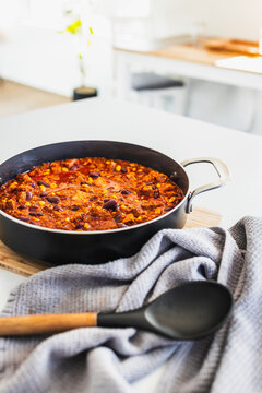 homemade vegetarian tempeh kidney bean chilli with corn in cooking pot