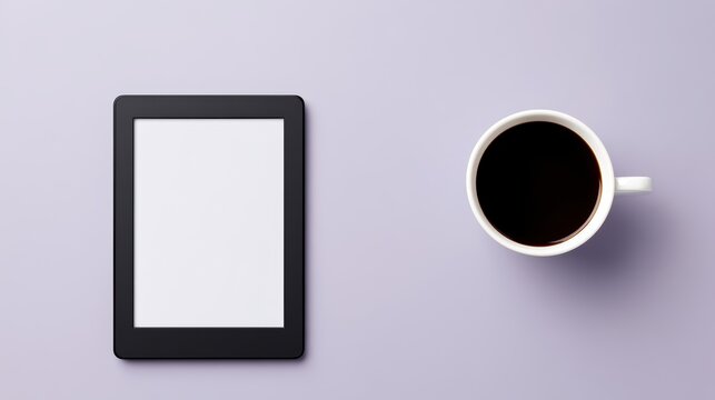 Digital e reader tablet with blank screen beside cup of coffee on solid lavender purple minimalist desk background