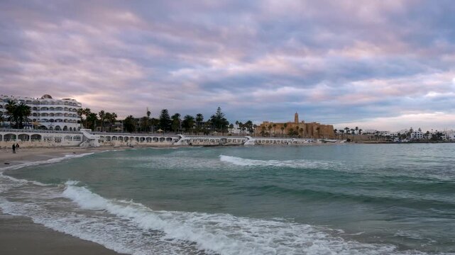 Moody seascape at Monastir, Tunisia, the fort ribat and Mediterranean sea under dramatic storm clouds and soft light, conveying tranquility, travel mood, and coastal atmosphere