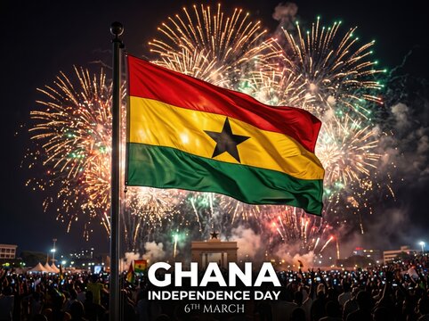 Waving flag of ghana on a flagpole against a night sky filled with bright golden fireworks and a large crowd of people celebrating independence day on the sixth of march