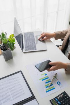 Asian businesswoman using smartphone working in office