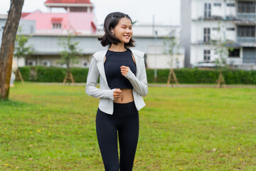 Fototapeta premium Asian sporty woman running in public park