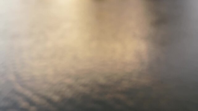 Abstract Blurred Golden Light Reflection on Dark Water