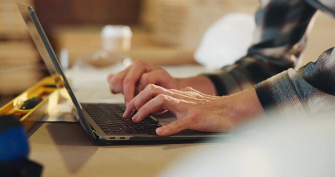 Carpentry, typing and hands of man on laptop for furniture order, project dimensions and email. Workshop, computer and person on tech for planning, report or timber inventory for woodworking business