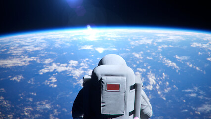 Zoom Out Back View of Astronaut Floating Alone in Outer Space Viewing Sunrise Over Earth Atmosphere, Visionary Concept. © SohubProduction