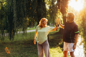 Naklejka premium Senior couple high fiving celebrating active lifestyle