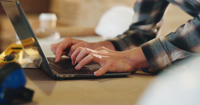 Carpentry, workshop and hands of man on laptop for furniture order, project dimensions or email. Typing, computer and person for planning, schedule update or timber inventory for woodworking business
