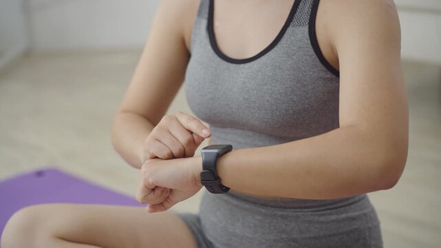 Close Up of Woman Hands Touching Smart Watch Screen to Check Fitness Data after Workout