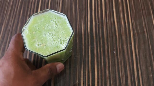 Glass of Fresh Green Tomato Juice Placed on Wooden Table
