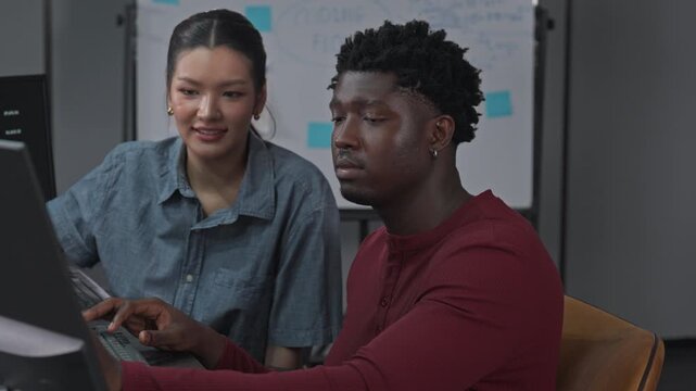 Female and male developers engage in pair programming with sprint planning, collaborating on code review and task execution within workflow.