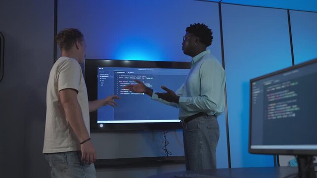 Diverse male developers collaborate on system architecture and workflow troubleshooting, demonstrating technical problem-solving and integrated solution design discussion.