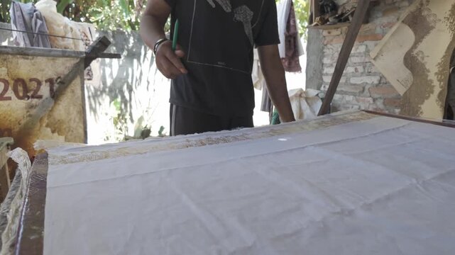 Batik Artisan Measuring and Marking Fabric Before Traditional Batik Stamp Process in 4K