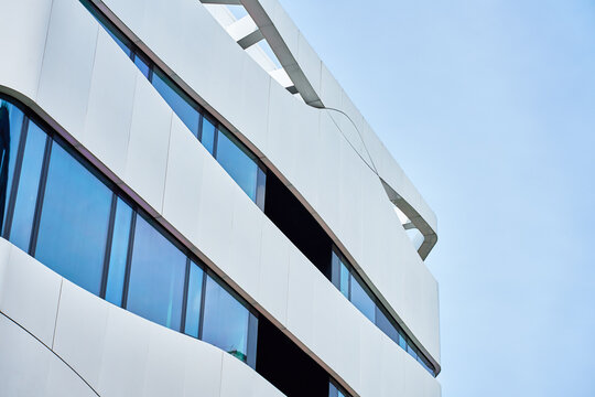 Modern office building with curved white facade