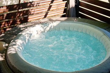 Obraz na płótnie Canvas Inflatable Hot Tub with Bubbling Water on Outdoor Terrace