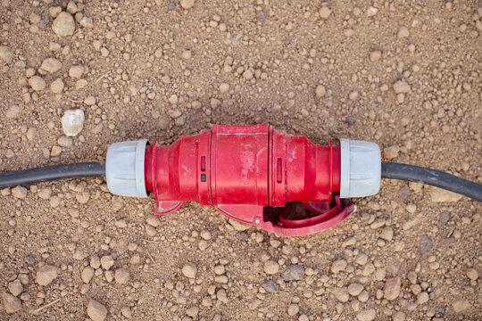 Industrial power cable connector lying on the ground