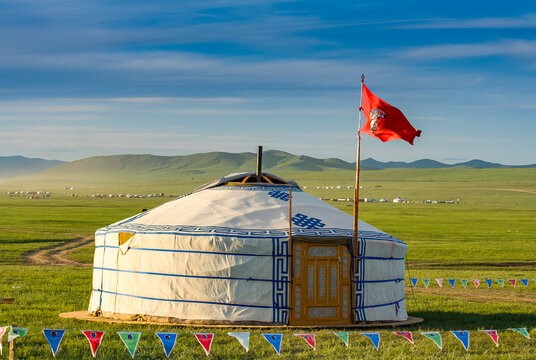Traditional nomadic ger home with flag on the grass steppe of Mongolia