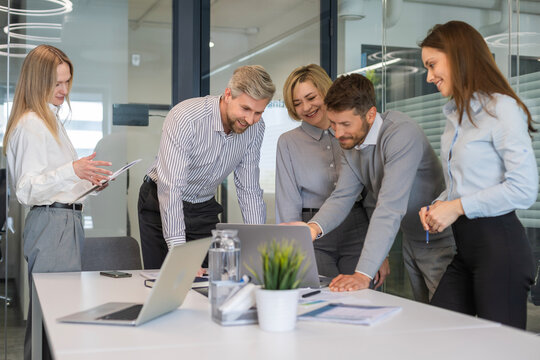 Group of happy progressive business people working on startup together at creative office