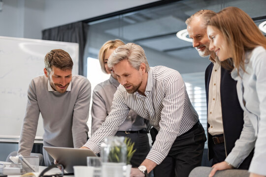 Group of happy progressive business people working on startup together at creative office