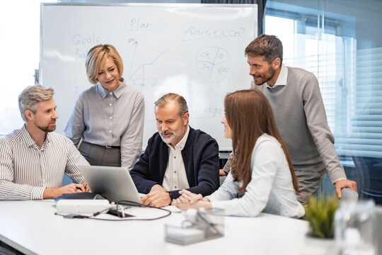 Group of happy progressive business people working on startup together at creative office