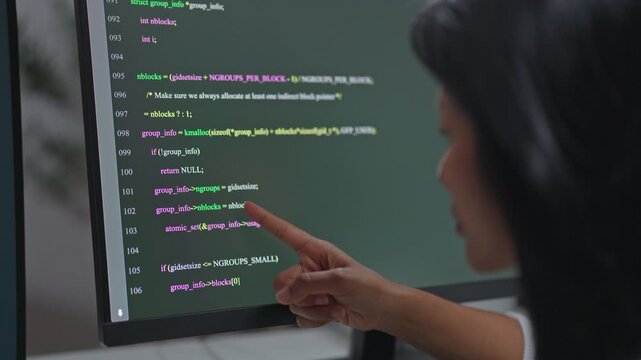 Asian woman programmer pointing finger at error line in AI generated code on monitor, inspecting and verifying bugs from artificial intelligence