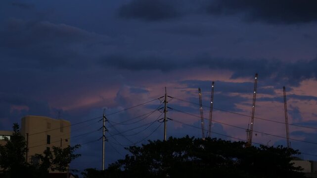 Tower Cranes Silhouette Construction Site Dramatic Dusk Sky Clouds Powerline Urban Skyline Twilight Footage Time Lapse City Development