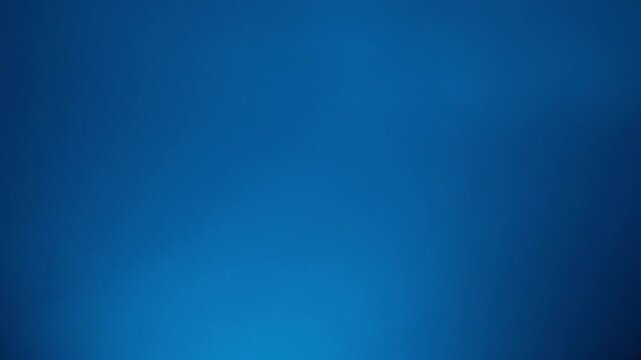 Abstract blue background with a smooth gradient and subtle light effects, creating a modern and clean aesthetic. This versatile backdrop is digital design, technology concepts, and corporate