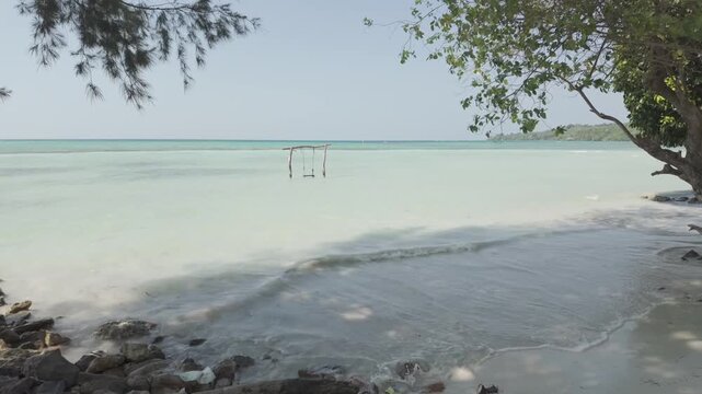 Peaceful Tropical Beach with Wooden Swing Over Clear Water at Bobby Beach Full HD