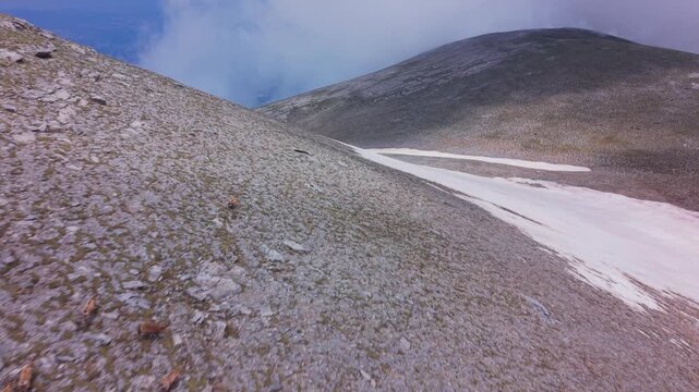 Aerial View of Wild Chamois Herd Running Across Rocky Slope on Mount Olympus