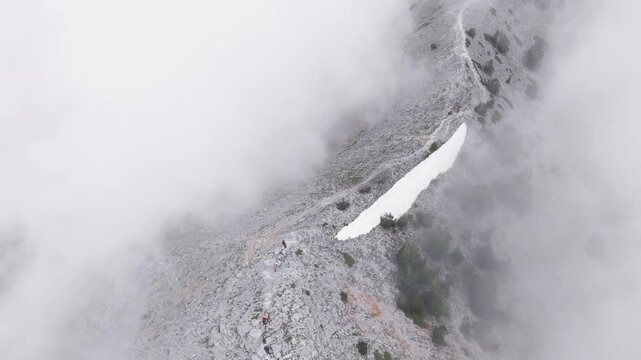 Aerial View of Pack Mules Ascending Rocky Ridge on Mount Olympus in Heavy Fog