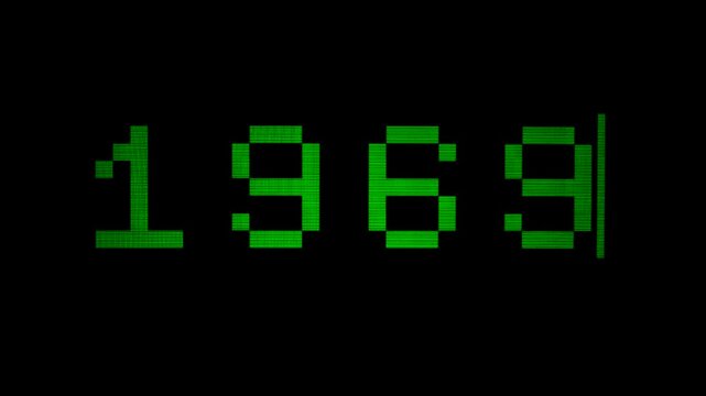 Capture: green pixelated text 1969 typing out on a retro computer monitor screen. A blinking cursor indicates active input. The old-school digital aesthetic evokes nostalgia for early computing.
