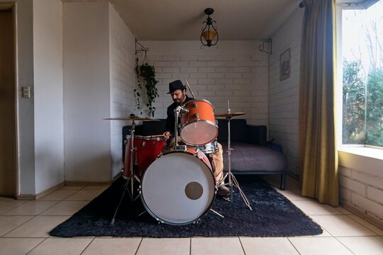 A jazz drummer practices at home