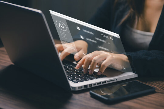 Businesswoman interacting with an AI chatbot interface on a laptop, showcasing artificial intelligence, virtual assistant technology, digital communication, automation and smart business productivity.