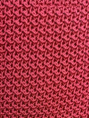artistic traditional knitted texture using maroon thread