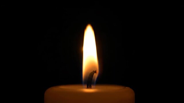 Close-up footage of burning candle flames, flickering candlelight of burning candles