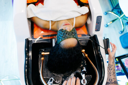 Woman enjoying a relaxing hair wash and spa treatment