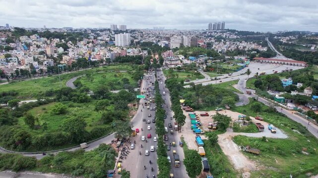 Aerial panoramic view showing busy regular traffic on lush bangalore mysore highway during winter