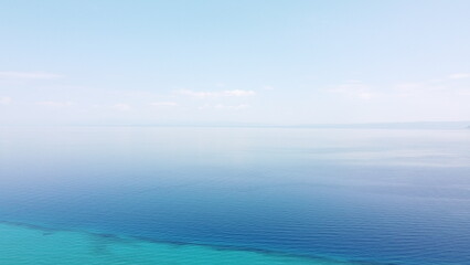 Fototapeta premium High Altitude Aerial View of Two Tone Turquoise and Deep Blue Ocean Water
